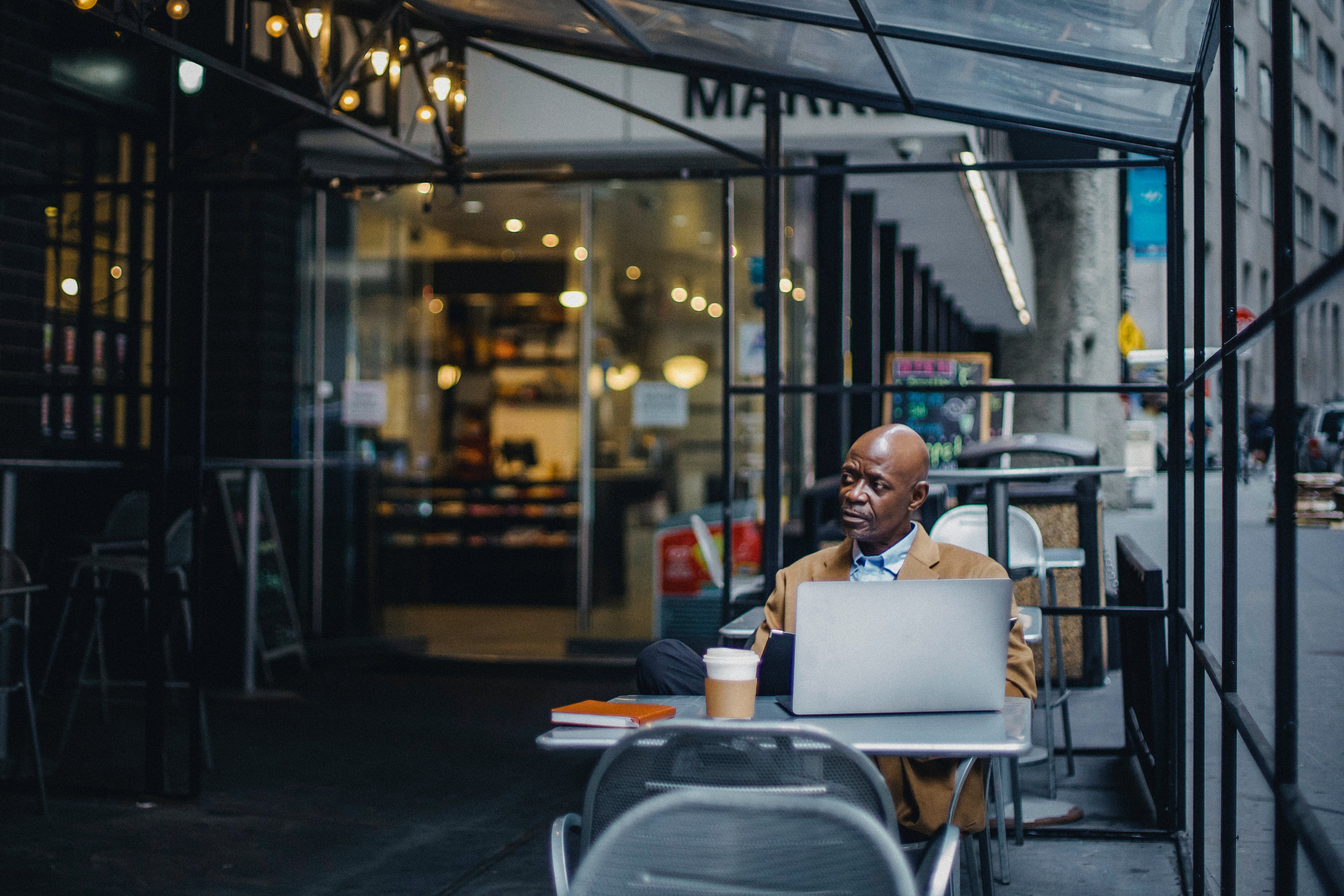 Ghanaian abroad working from a city café — staying connected to home